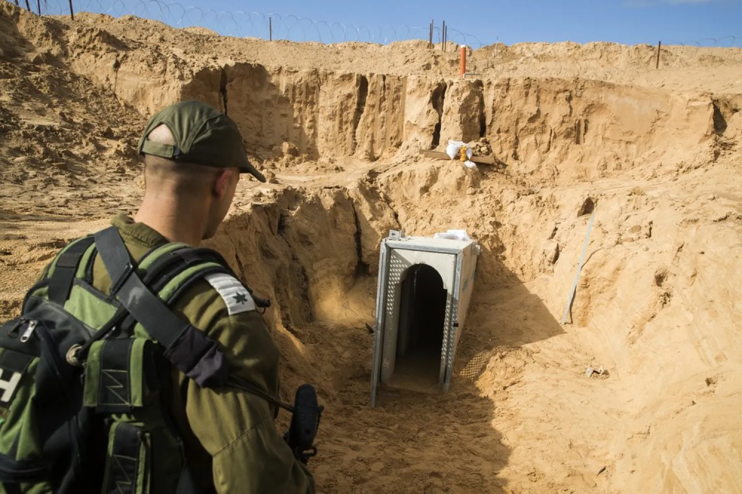 An Israeli soldier stands on the Israeli side of the border with Gaza, near the opening of a tunnel, that Israel says was dug by the Islamic Jihad group, leading from Gaza into Israel, near the southern Israeli kibbutz of Kissufim, Israel, Thursday, Jan. 18, 2018. (Jack Guez/Pool via AP)
