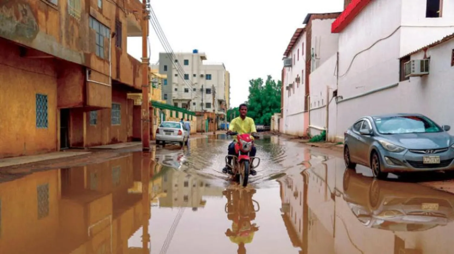 A man rides a motorbike in a pool of water following heavy rain in Sudan's capital Khartoum, on August 13, 2022. (AFP) 

