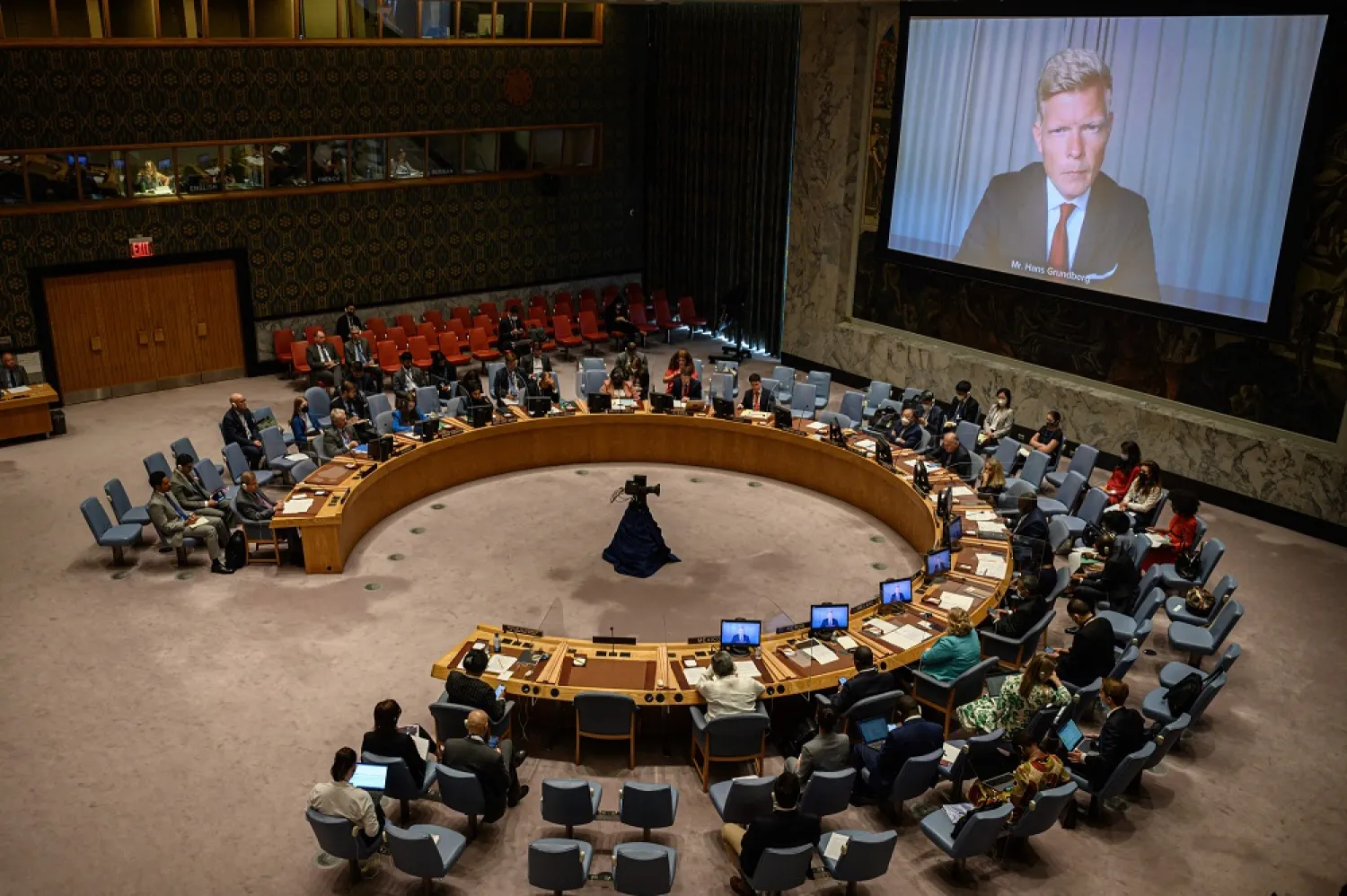 United Nations Special Envoy for Yemen Hans Grundberg (R) is displayed on a screen as he attends remotely a Security Council meeting on the situation in the Middle East at the United Nations headquarters in New York City on August 15, 2022. (AFP)