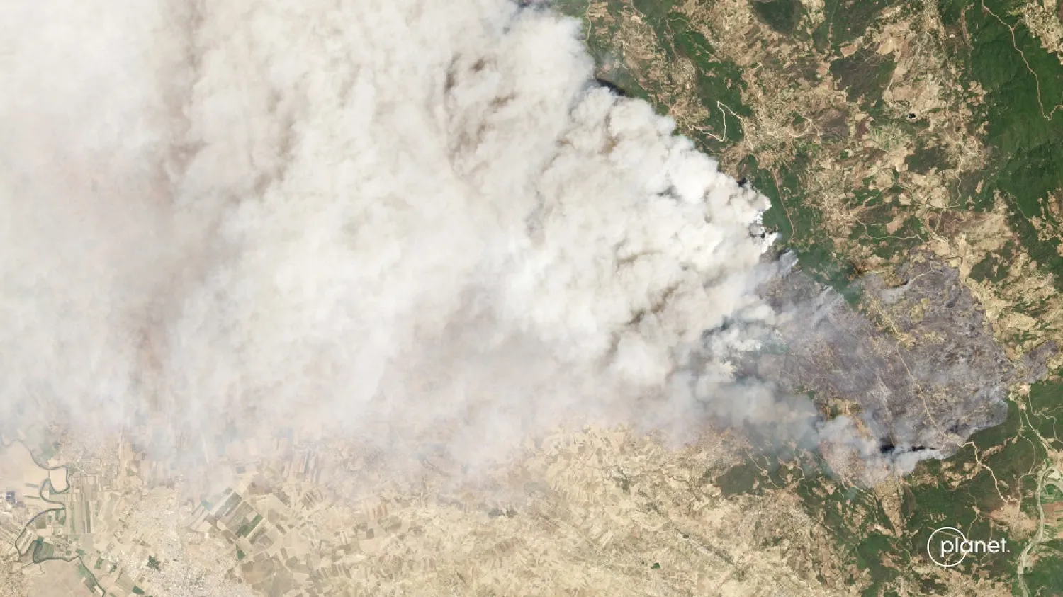 This satellite image from Planet Labs PBC shows smoke rising from a fire burning in the northern town of Ouazzane, Morocco, Thursday, July 14, 2022. (Planet Labs PBC via AP)