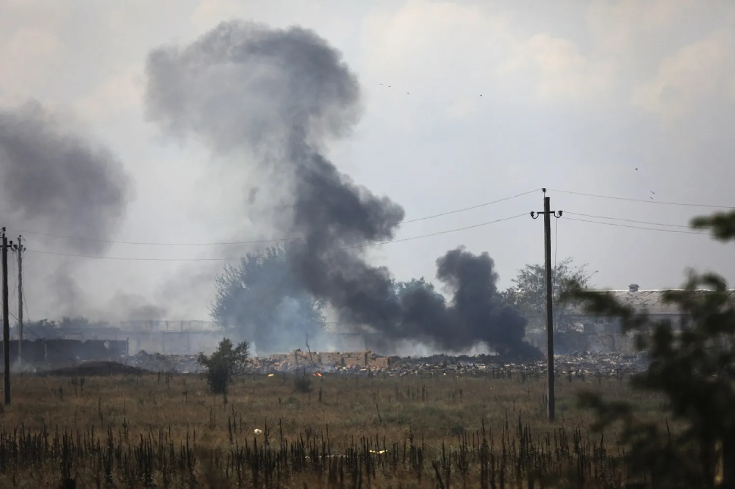 Smoke rises over the site of explosion at an ammunition storage of Russian army near the village of Mayskoye, Crimea, Tuesday, Aug. 16, 2022. (AP)