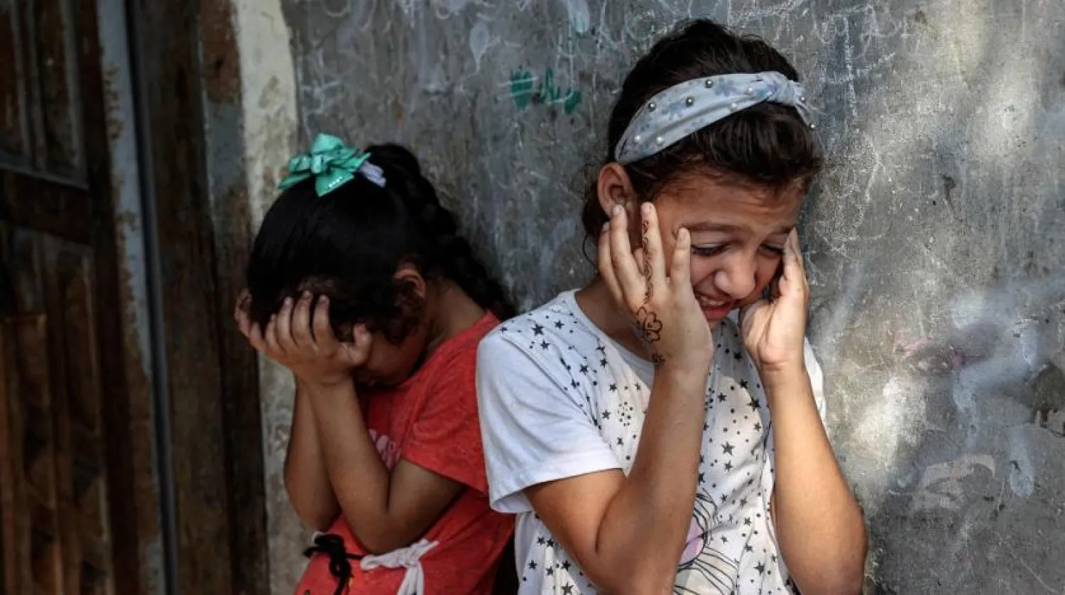 Friends react during the funeral of Palestinian child Lian al-Shaer, after she succumbed to her injuries sustained in last week's Israeli air strikes, in Khan Younis in the southern Gaza Strip, on August 11, 2022. (AFP)
