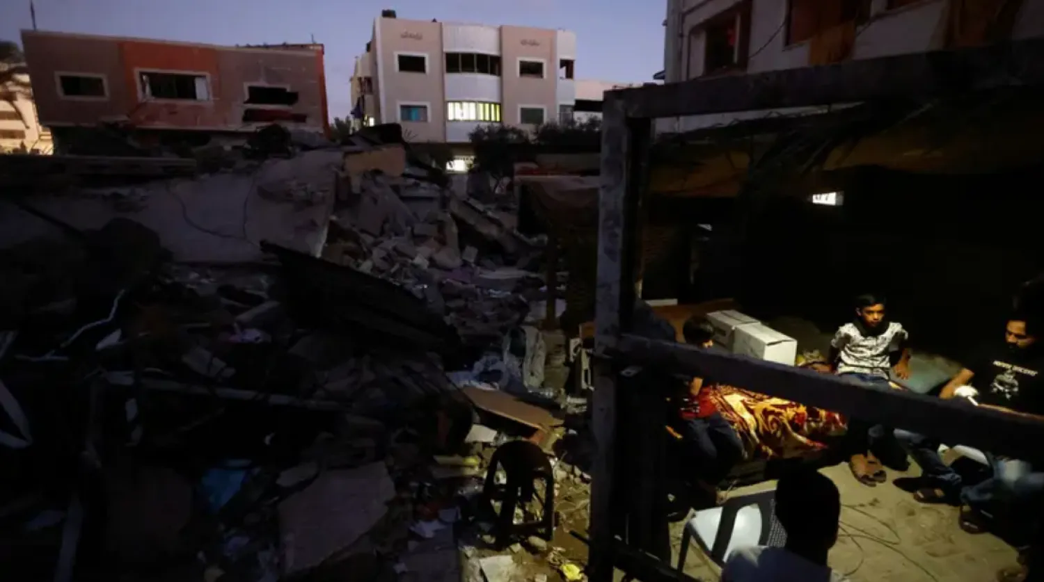 Palestinians sit in a shelter at the rubble of their house destroyed in the three-day Israel-Gaza fighting, in Gaza City, August 14, 2022 - Reuters 
