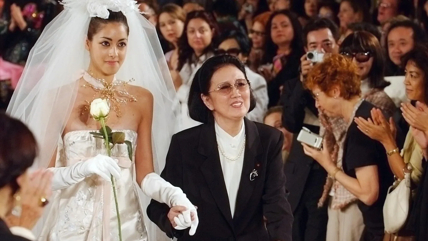 Japanese fashion designer Hanae Mori, center, receives applause at the end of her Fall/Winter 2004-2005 Haute Couture fashion show in Paris. AP