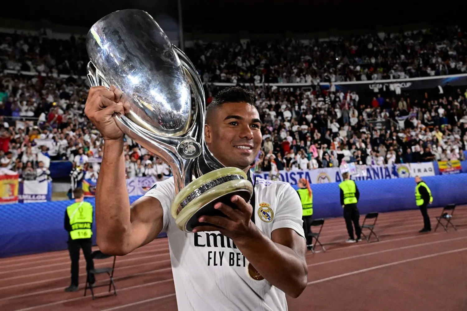 Real Madrid's Brazilian midfielder Casemiro celebrates with the trophy after the UEFA Super Cup football match between Real Madrid vs Eintracht Frankfurt in Helsinki, on August 10, 2022. (AFP)