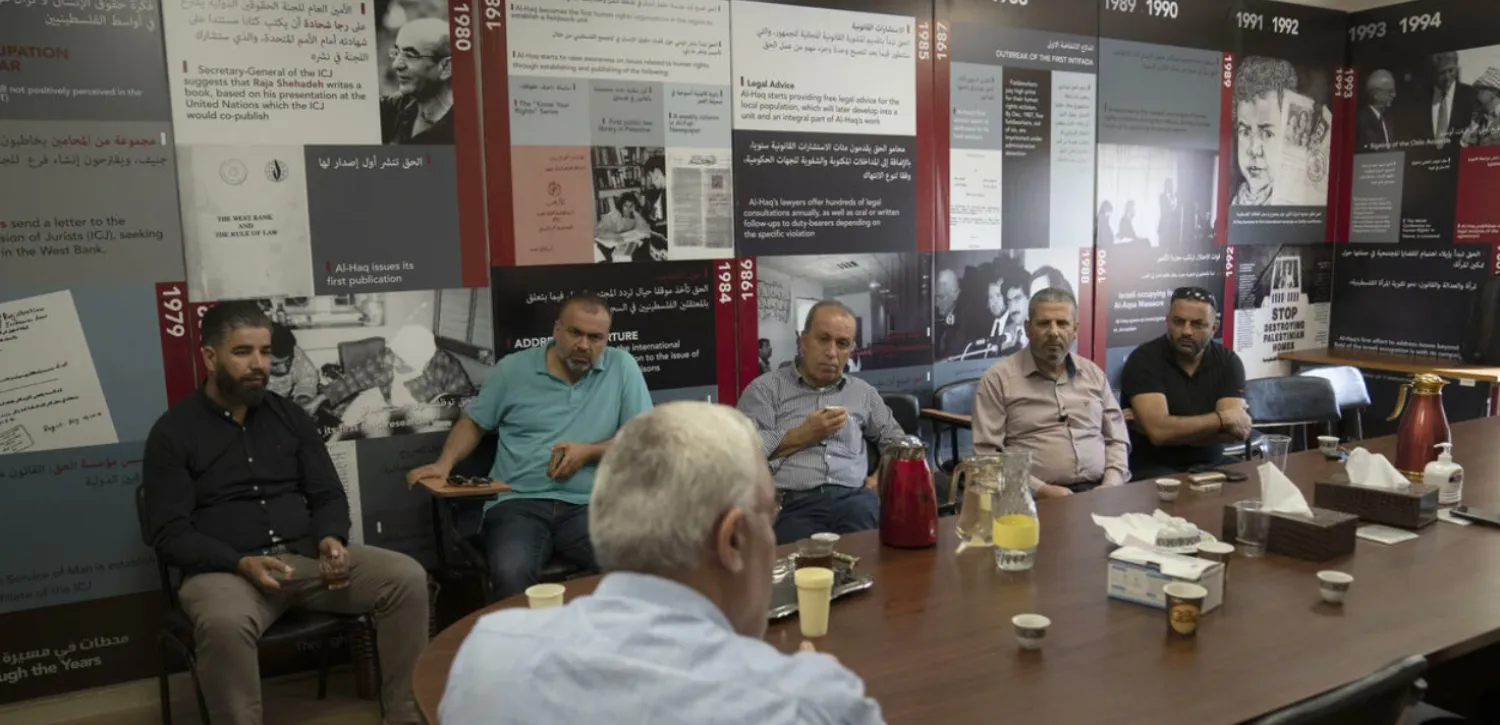 Shawan Jabarin, director of al-Haq Human rights organization, front, briefs activists at his office in the West Bank city of Ramallah, Thursday, Aug. 18, 2022. © Nasser Nasser, AP
