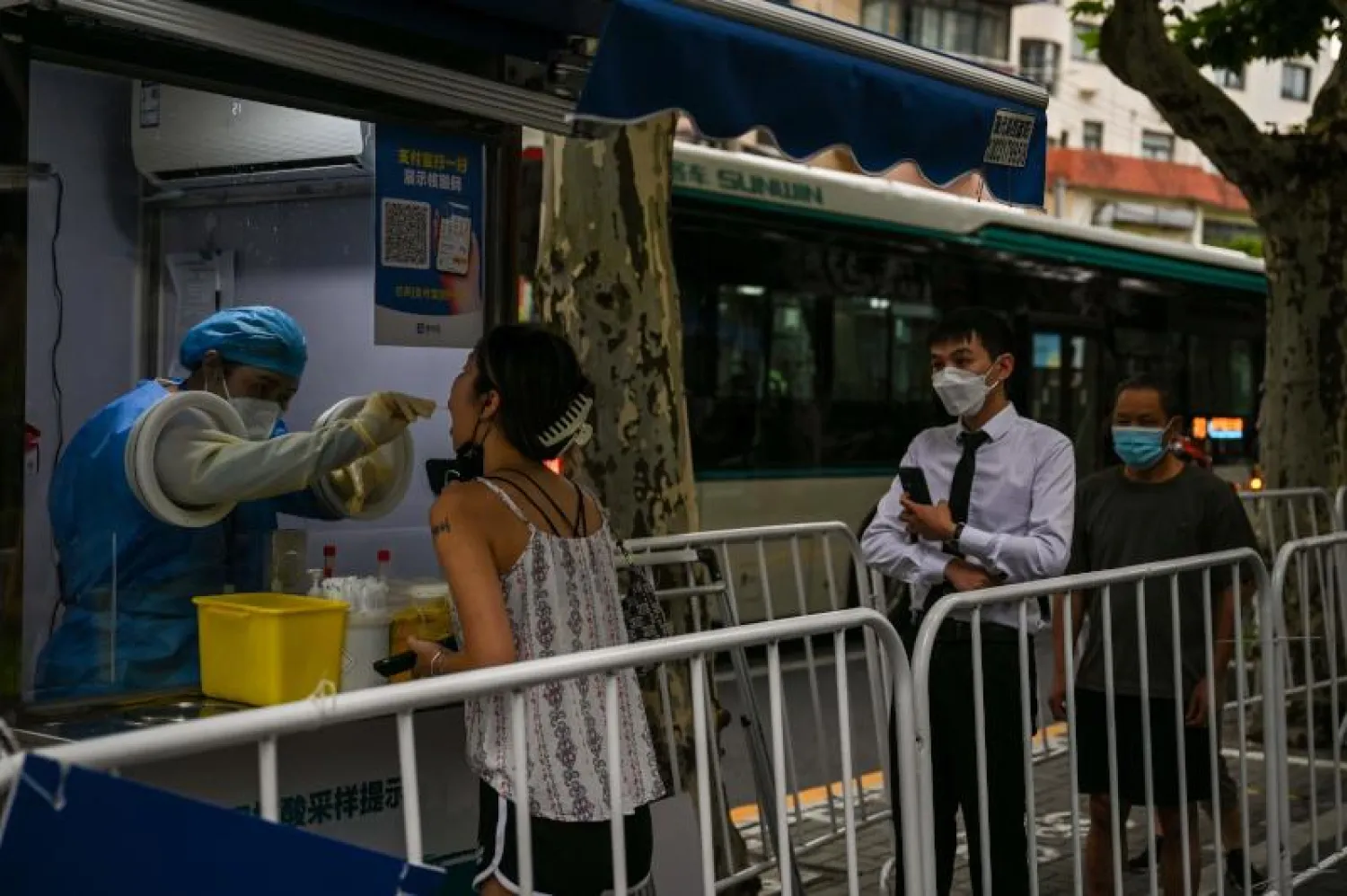 أشخاص يجرون اختبار فيروس «كورونا» في شنغهاي (أ.ف.ب)