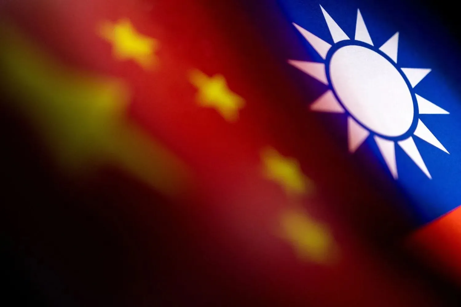 Chinese and Taiwanese printed flags are seen in this illustration taken, April 28, 2022. REUTERS/Dado Ruvic/Illustration
