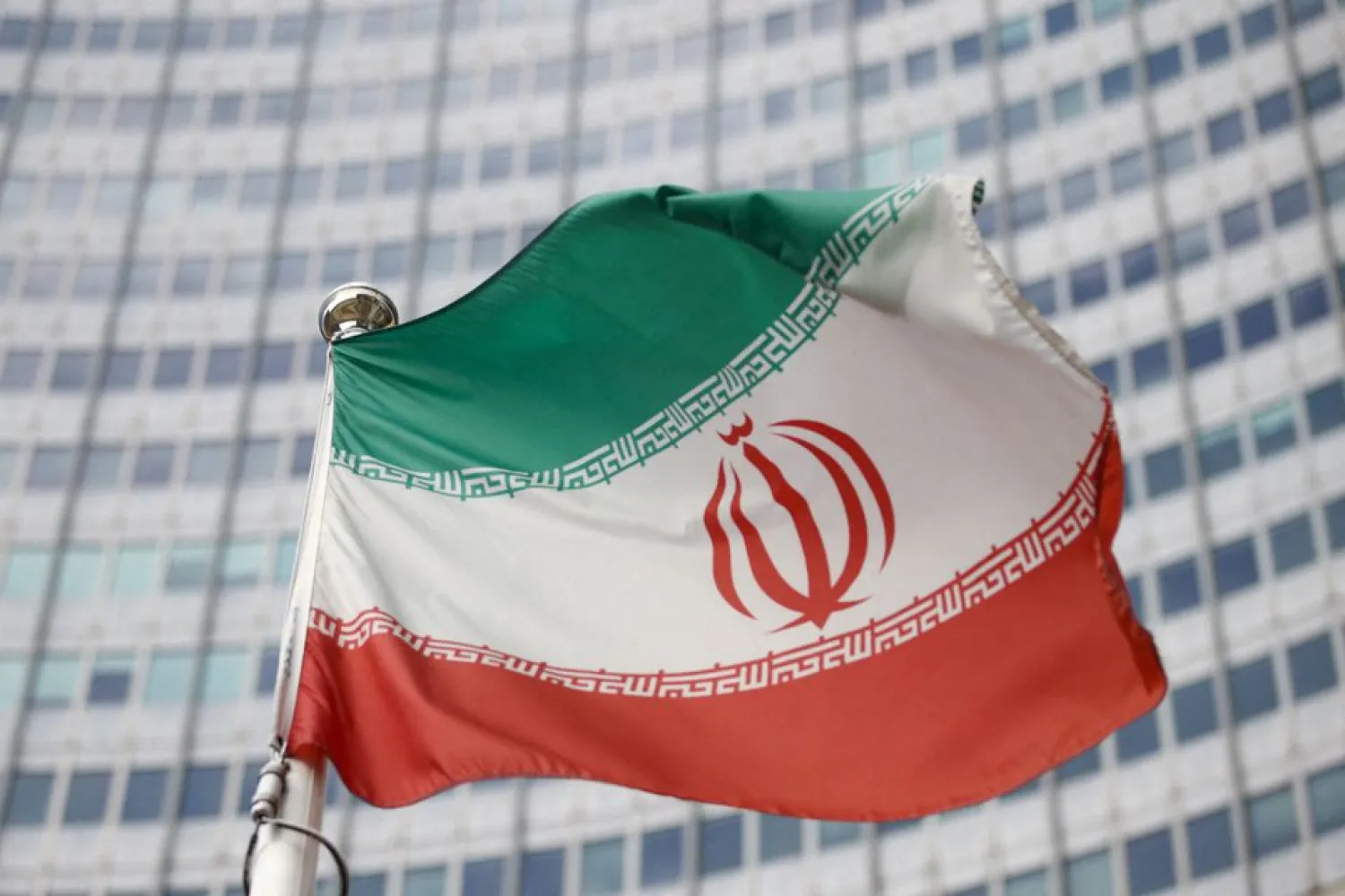 The Iranian flag waves in front of the International Atomic Energy Agency (IAEA) headquarters in Vienna, Austria, March 1, 2021. REUTERS/Lisi Niesner/File Photo