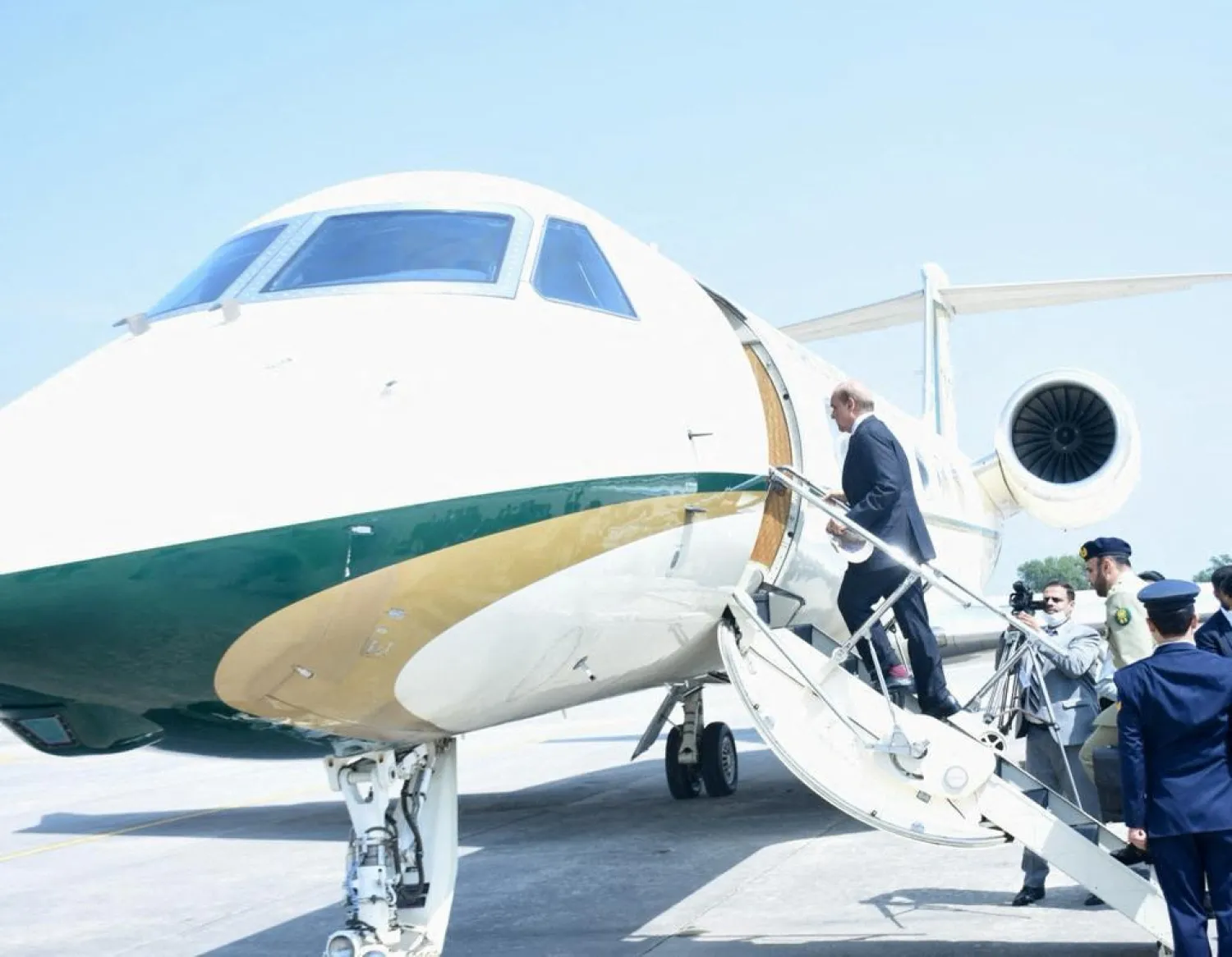 Pakistan's Prime Minister Shehbaz Sharif boards a plane as he leaves for the two days official visit in Doha, Qatar, in Islamabad, Pakistan August 23, 2022. (Press Information Department/Handout via Reuters)