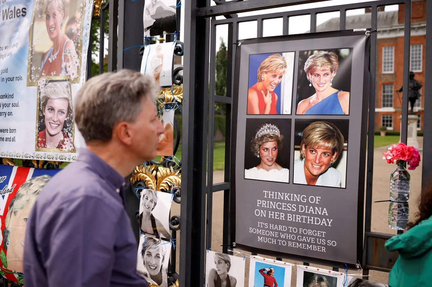 A person looks at tributes for Britain's Princess Diana, outside Kensington Palace, before the installation of a statue in honor of Princess Diana, in London, Britain, July 1, 2021. (Reuters)
