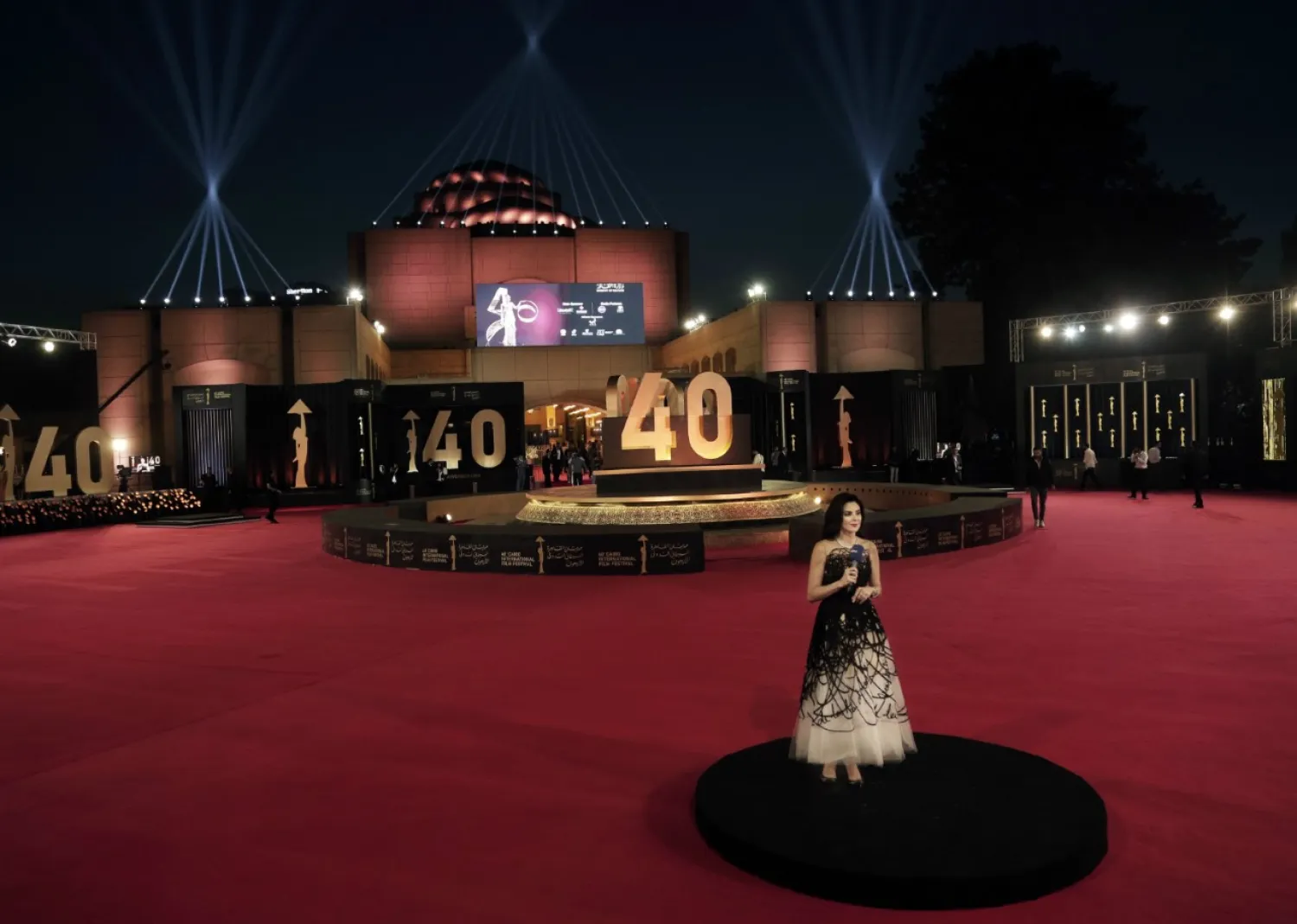 A presenter tests her mic on the red carpet during the opening of the 40th Cairo International Film at the Opera House in Egypt, Tuesday, Nov. 20, 2018. [Photo: AP/Nariman El-Mofty]