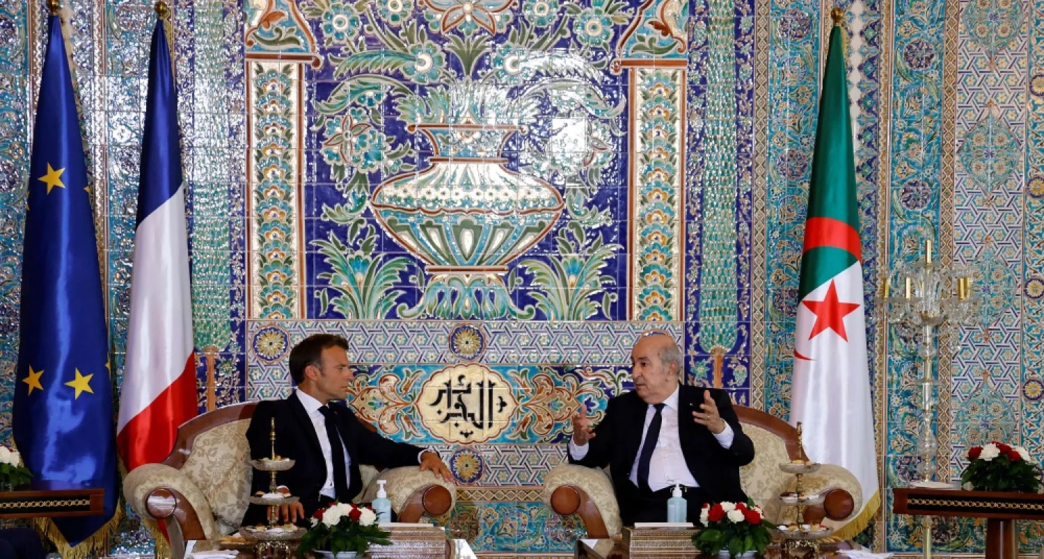 French President Emmanuel Macron (L) and Algeria's President Abdelmadjid Tebboune attend a meeting at the VIP lounge of the airport in Algiers on August 25, 2022, at the start of an official visit to Algeria. (AFP)
