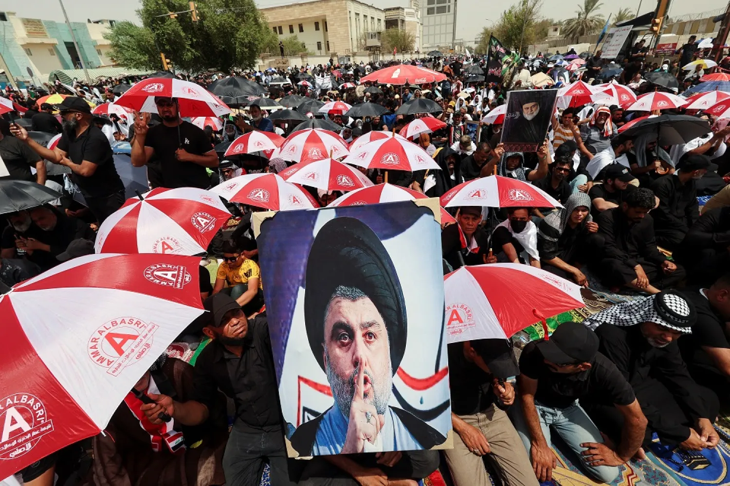 Supporters of Iraqi populist leader Moqtada al-Sadr gather for Friday prayers outside the parliament near the Green Zone, in Baghdad, Iraq August 26, 2022. (Reuters)