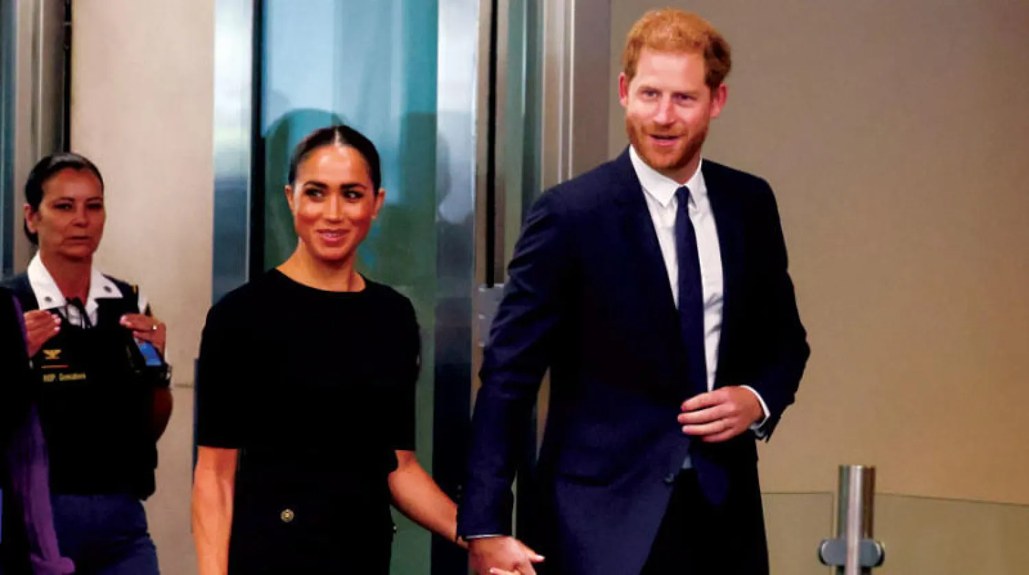 ميغان ماركل وزوجها والأمير هاري (رويترز)