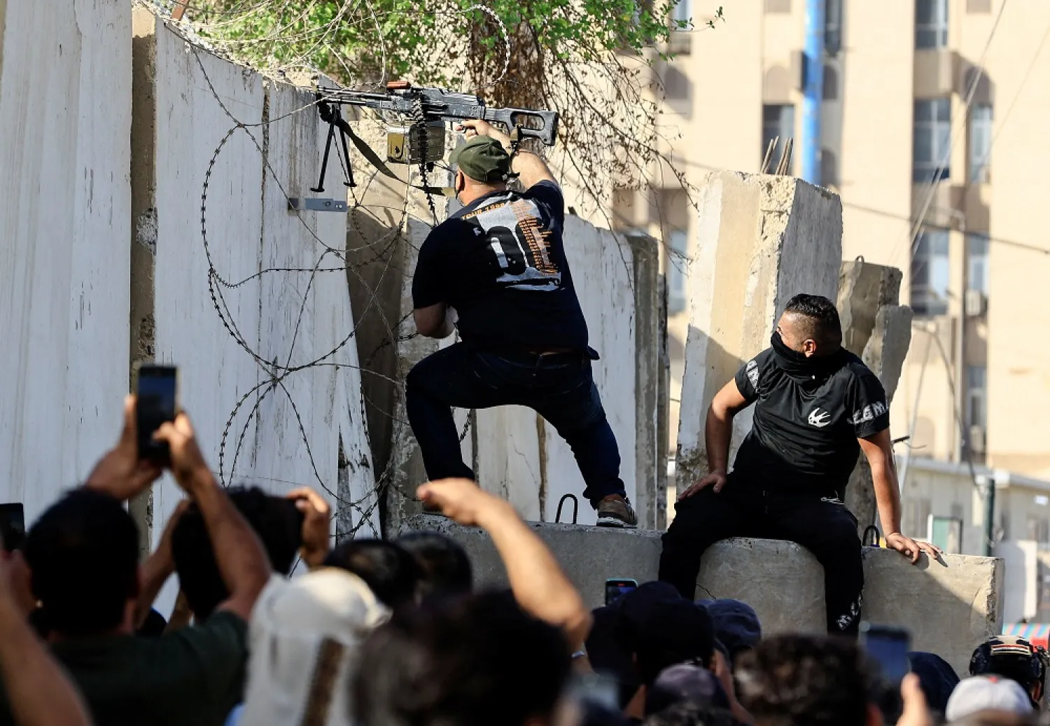 A member of Sadr's Saraya al-Salam fighters fires his weapon during clashes with the Iraqi security forces near the Green Zone, in Baghdad, Iraq August 30, 2022. (Reuters)