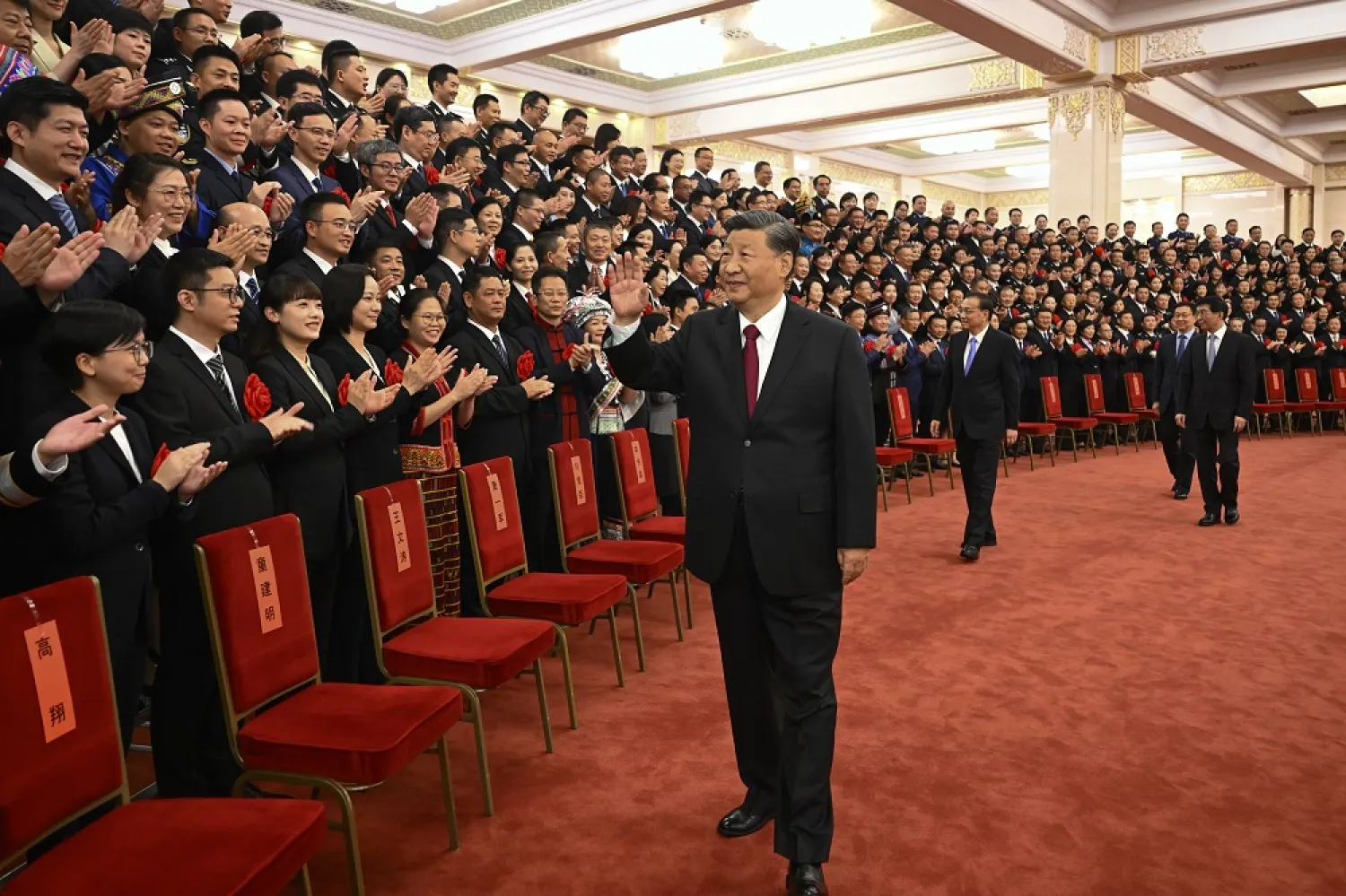 In this photo released by Xinhua News Agency, Chinese President Xi Jinping, center, and his premier Li Keqiang, center right, meet with representatives of model civil servants during a national award ceremony held at the Great Hall of the People in Beijing, Tuesday, Aug. 30, 2022. (Xinhua via AP)