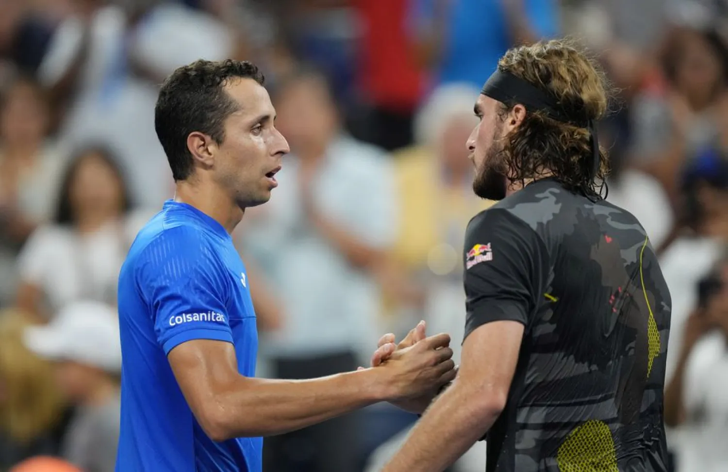 Aug 29, 2022; Flushing, NY, USA; Daniel Elahi Galan of Colombia, left, and Stefanos Tsitsipas of Greece shake hands after their first round match on day one of the 2022 US Open tennis tournament at USTA Billie Jean King National Tennis Center. Mandatory Credit: Jerry Lai-USA TODAY Sports



