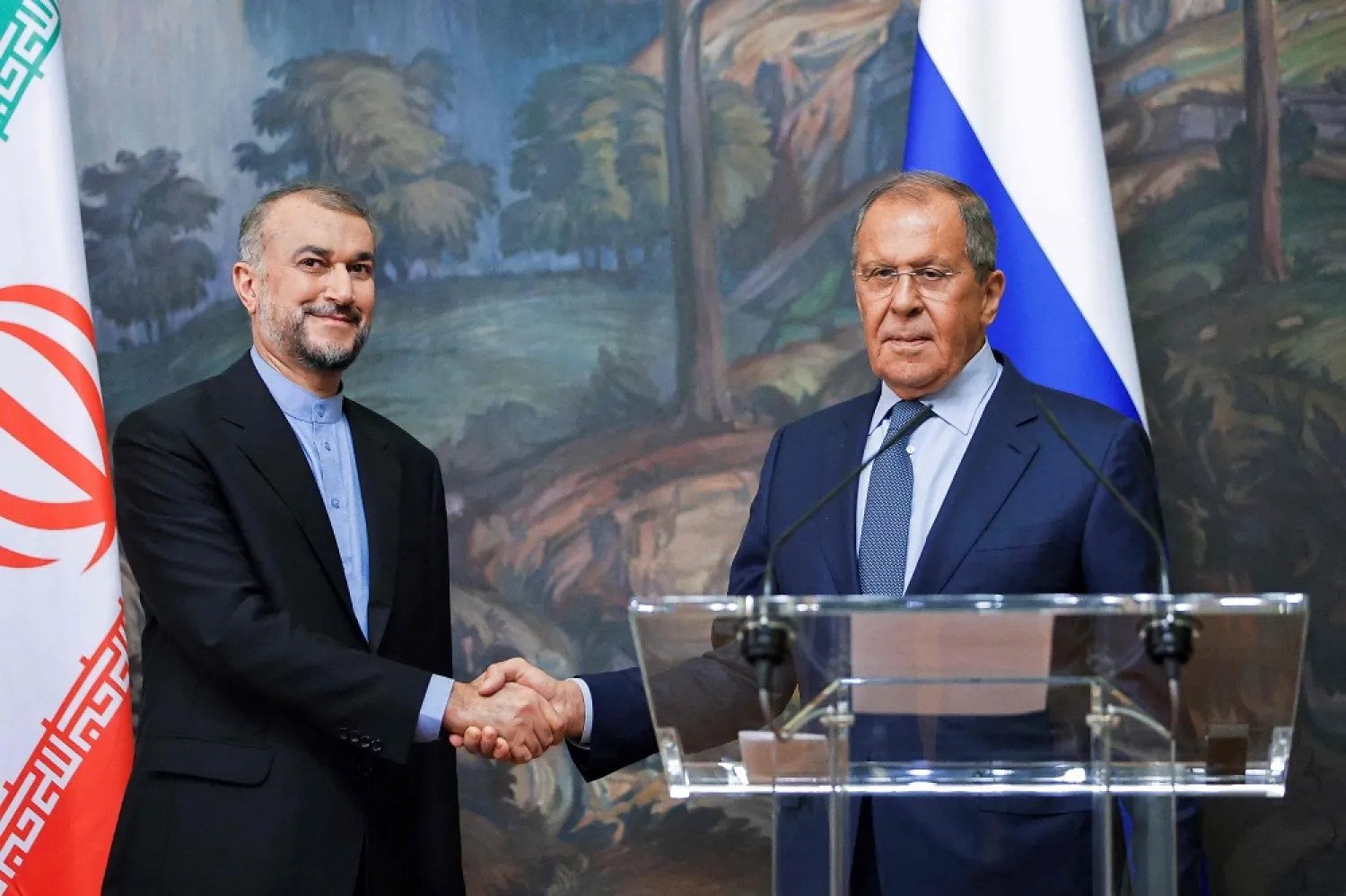 Russian Foreign Minister Sergei Lavrov (R) and Iranian Foreign Minister Hossein Amirabdollahian shake hands during a joint news conference as part of their meeting in Moscow, on August 31, 2022. (AFP)