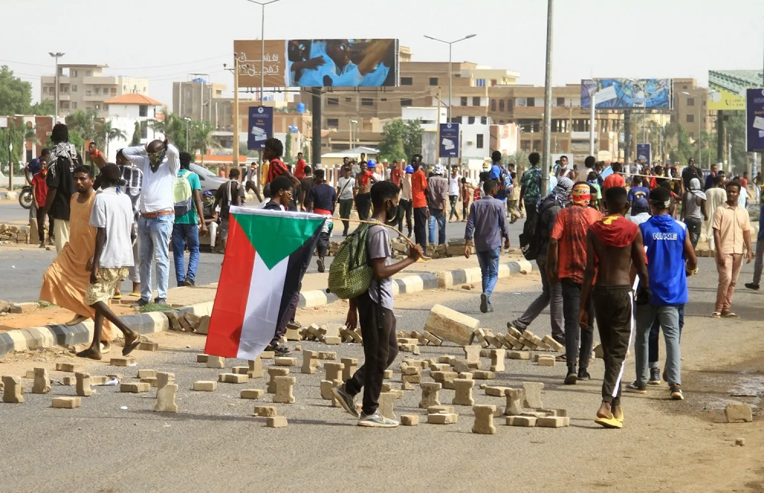 Sudanese youths protest near the airport in the south of the capital Khartoum on August 31, 2022, to demand the return of civilian rule. (AFP)
