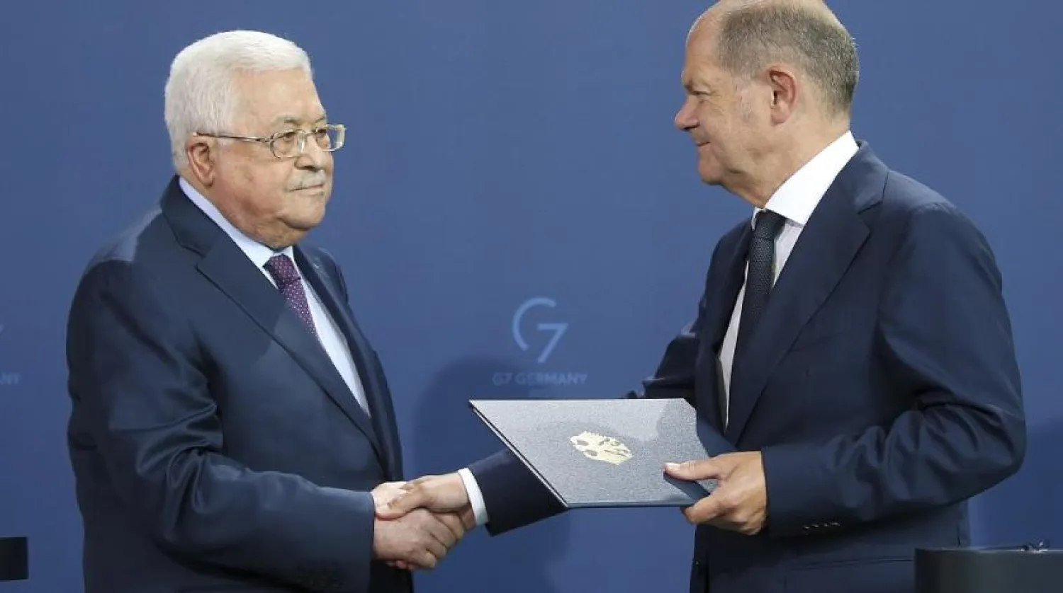 German Chancellor Olaf Scholz, right, and Mahmoud Abbas, President of the Palestinian Authority, shake hands after a press conference following talks in Berlin, Germany, Tuesday, Aug.16, 2022. (AP) 