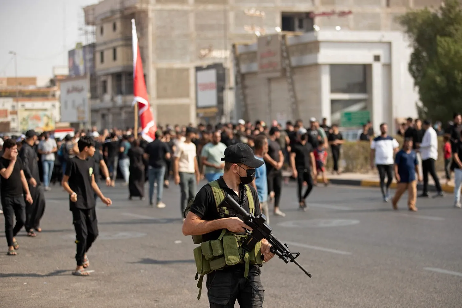 Iraqi mourners attend the funeral of two Saraya al-Salam fighters, an armed faction linked to Shiite cleric Moqtada Sadr, in the southern Iraqi city of Basra on September 1, 2022. (AFP)