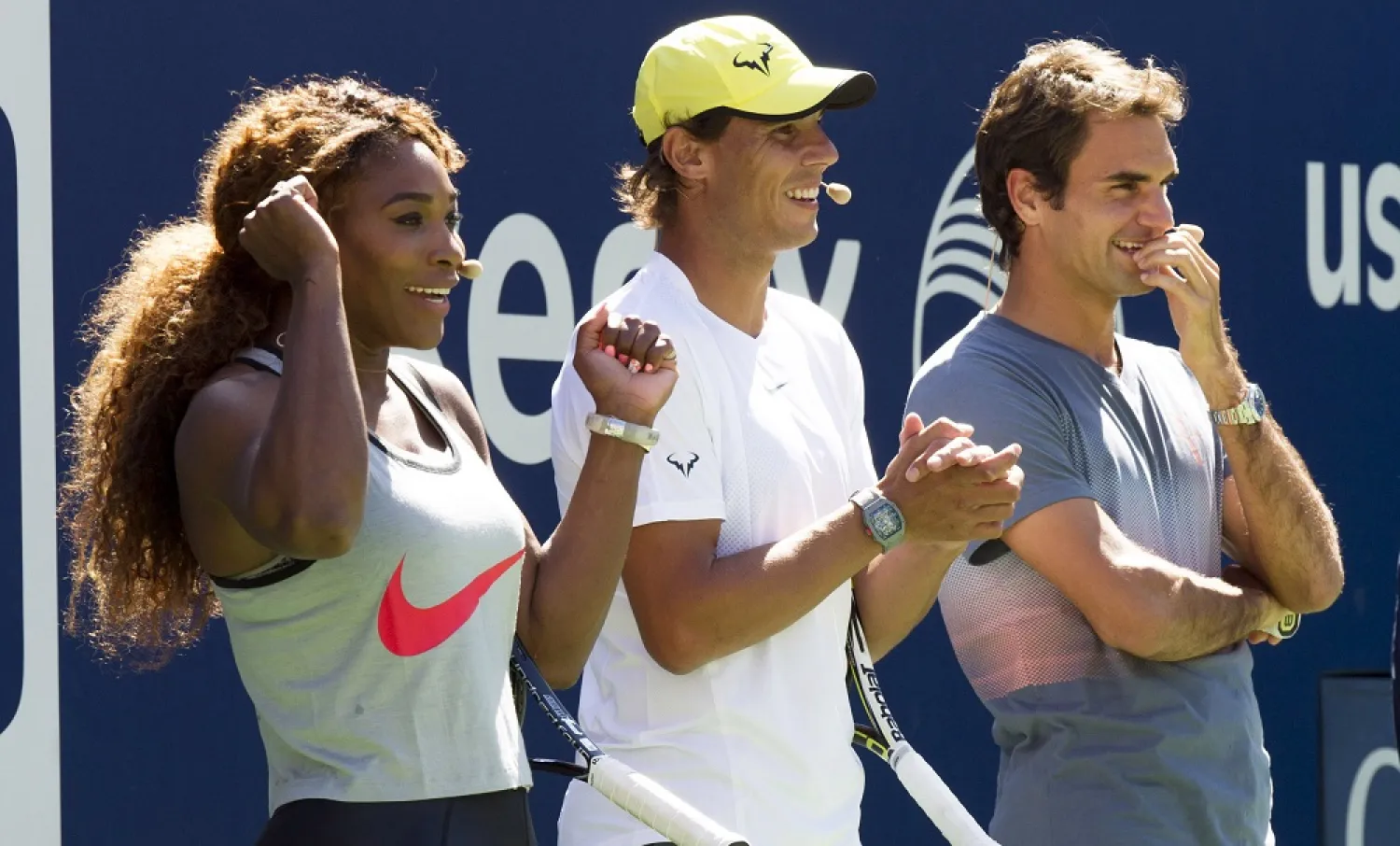 Serena Williams, Rafael Nadal and Roger Federer, right, cheer on the competition during Arthur Ashe Kids' Day, the kick off to the US Open tennis tournament, Aug. 24, 2013, in New York. (AP)