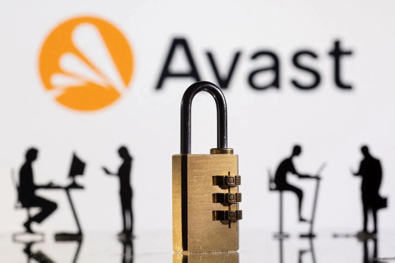 3D printed models of people working on computers and padlock are seen in front of a displayed Avast logo in this picture illustration taken, February 1, 2022. (Reuters)