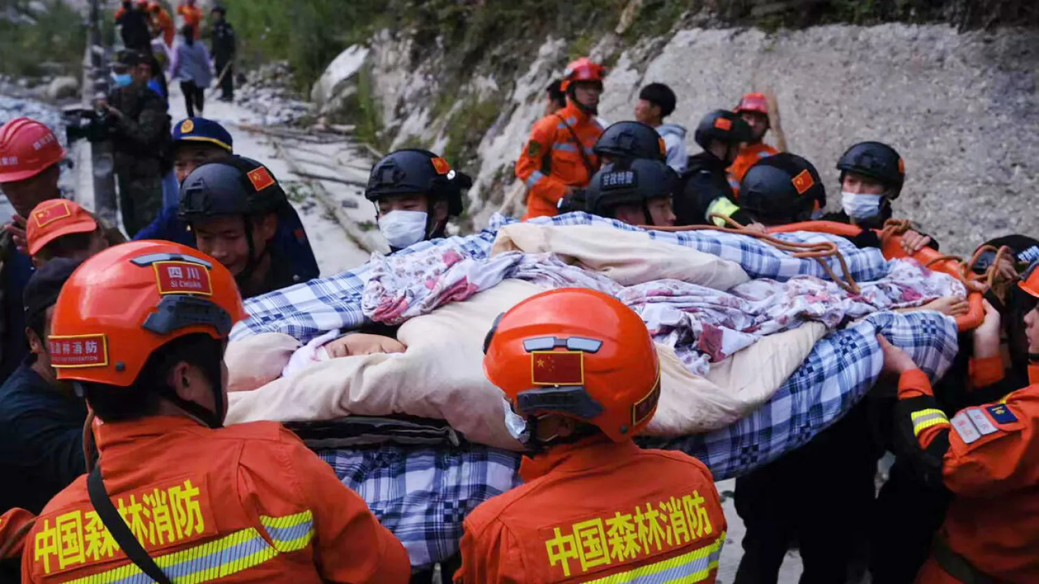 Rescue workers carry an injured person after a 6.6-magnitude earthquake struck China's southwestern Sichuan province on Monday STR CNS/AFP
