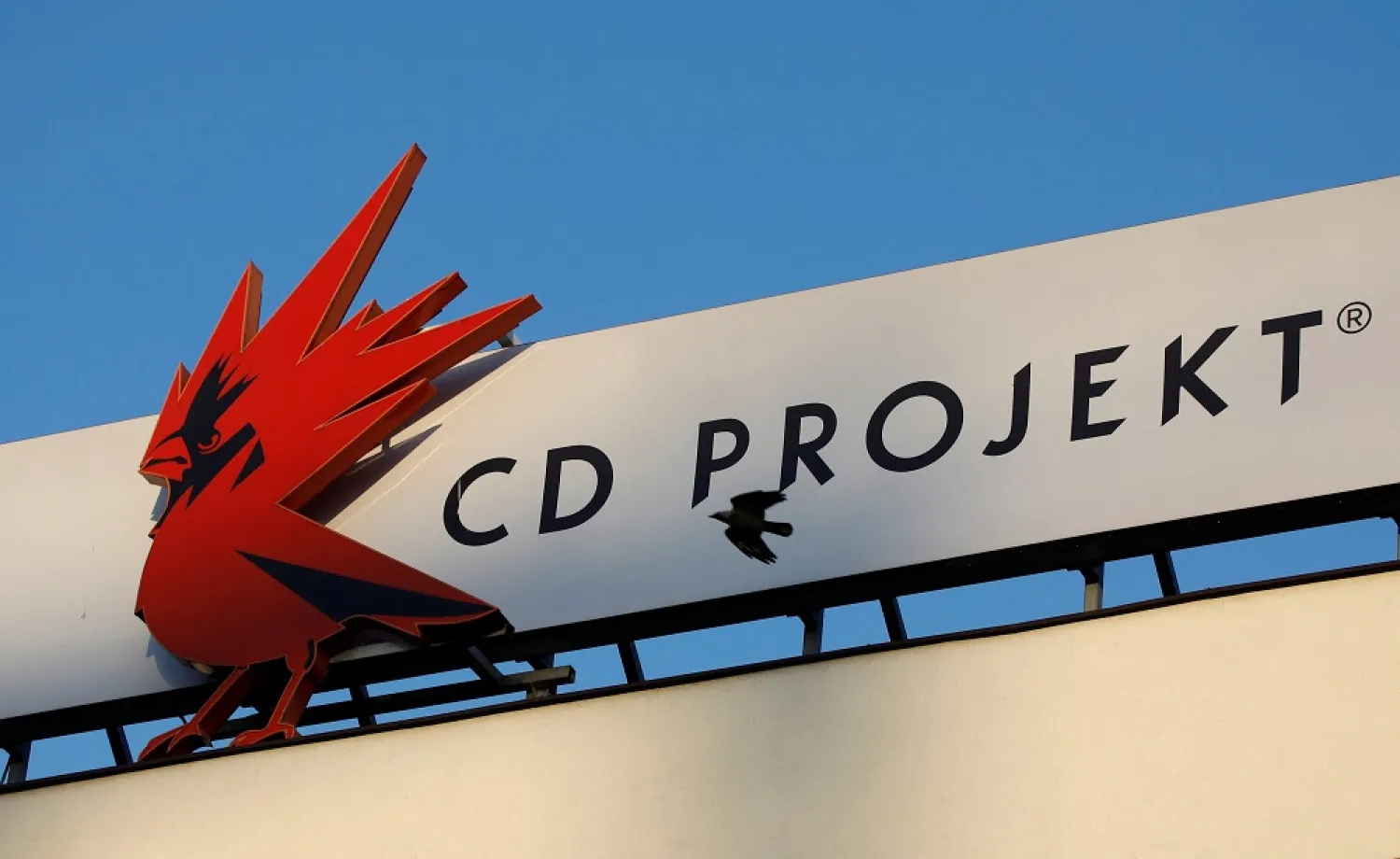 A bird flies in front of the CD Projekt logo at its headquarters in Warsaw, Poland January 21, 2020. (Reuters)