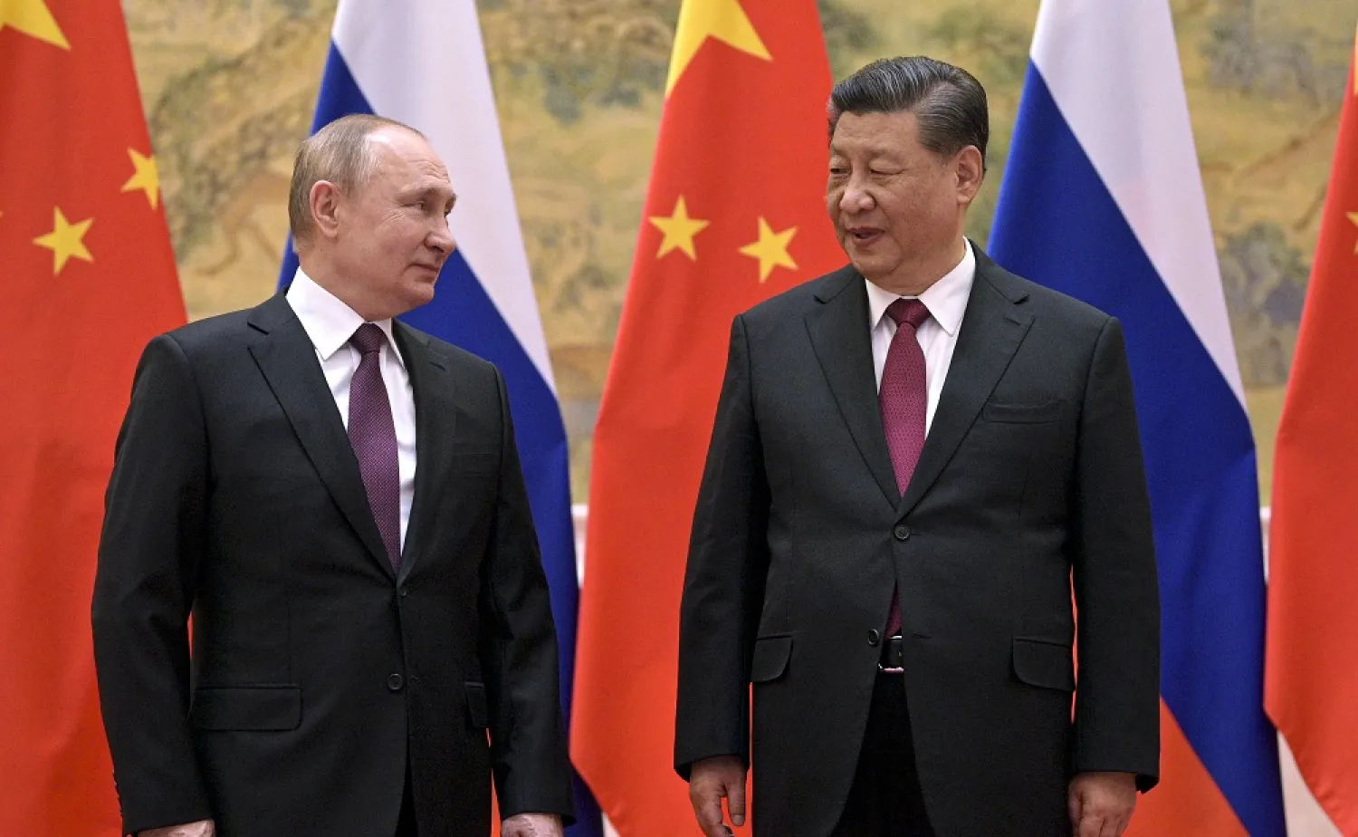 Chinese President Xi Jinping, right, and Russian President Vladimir Putin talk to each other during their meeting in Beijing on Feb. 4, 2022. (AP)