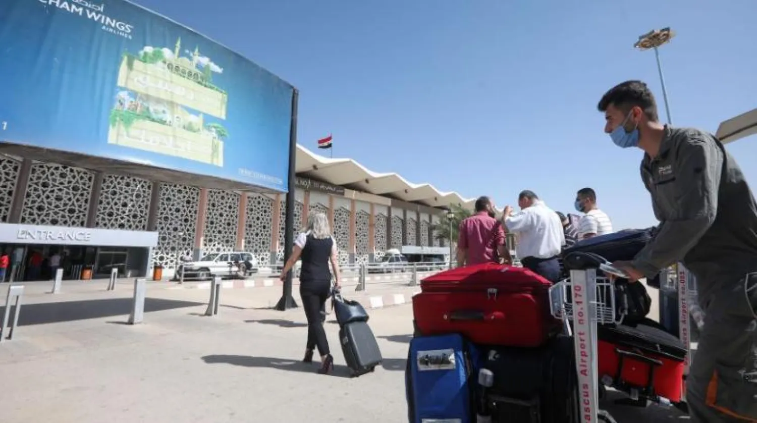 Passengers wearing protective face masks arrive at the Damascus International airport in the Syrian capital on Oct. 1, 2020. LOUAI BESHARA/AFP via Getty Images
