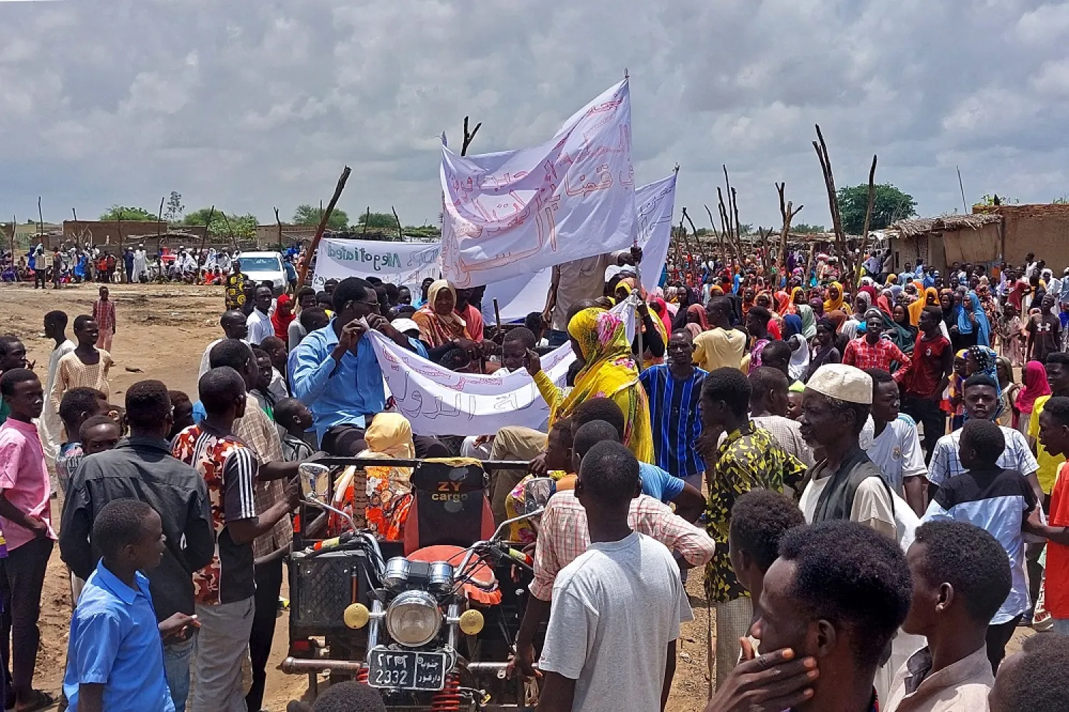 Sudanese gather to welcome the International Criminal Court's chief prosecutor Karim Khan (unseen) during his visit to the Kalma camp for internally displaced people in Nyala, the capital of South Darfur, on August 21, 2022. (AFP)