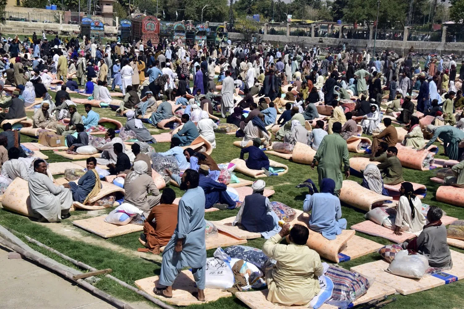 Victims of heavy flooding from monsoon rains receive relief aid in Quetta, Pakistan, Sunday, Sept. 11, 2022. (AP)