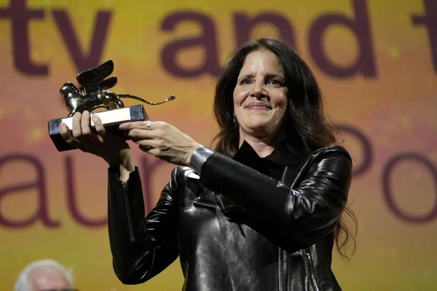 Director Laura Poitras holds the Golden Lion award for best film for "All the Beauty and the Bloodshed" at the closing ceremony of the 79th edition of the Venice Film Festival in Venice, Italy, Saturday, Sept. 10, 2022. (AP)