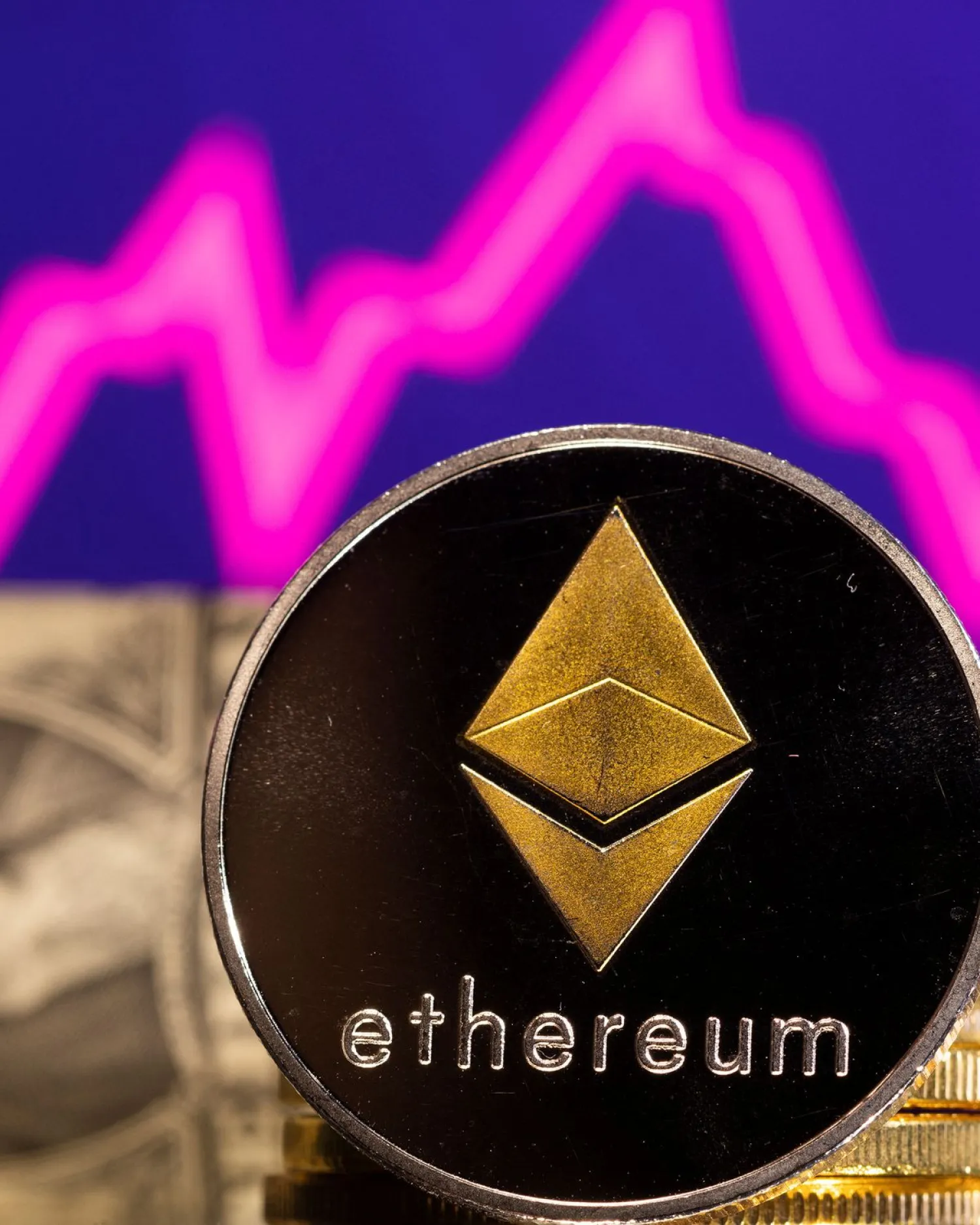 A representations of cryptocurrency Ethereum is seen in front of a stock graph and US dollar in this illustration taken, January 24, 2022. REUTERS/Dado Ruvic/Illustration/File Photo


