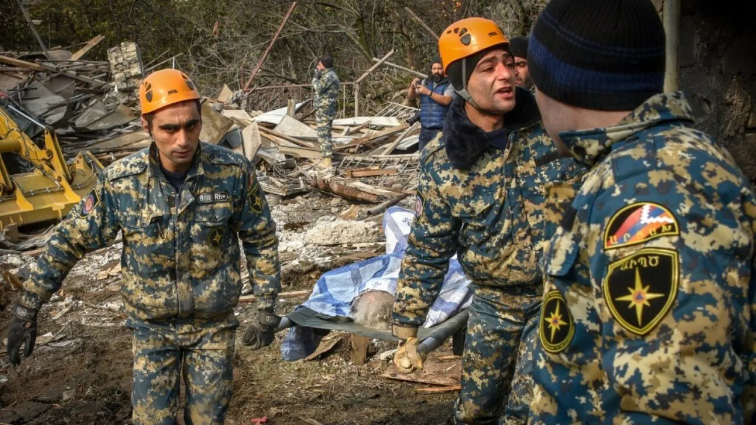 Rescuers carry the body of a woman killed by shelling during the military conflict over the Nagorno Karabakh region. Photo: Karen Minasya/AFP

