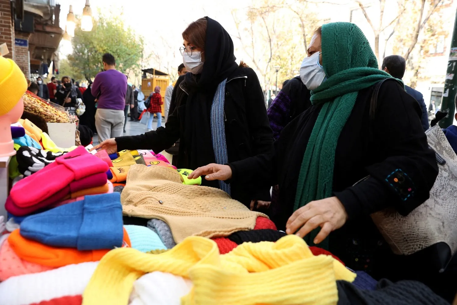 Women shop at a street in Tehran, Iran, November 29, 2021. (West Asia News Agency via Reuters)