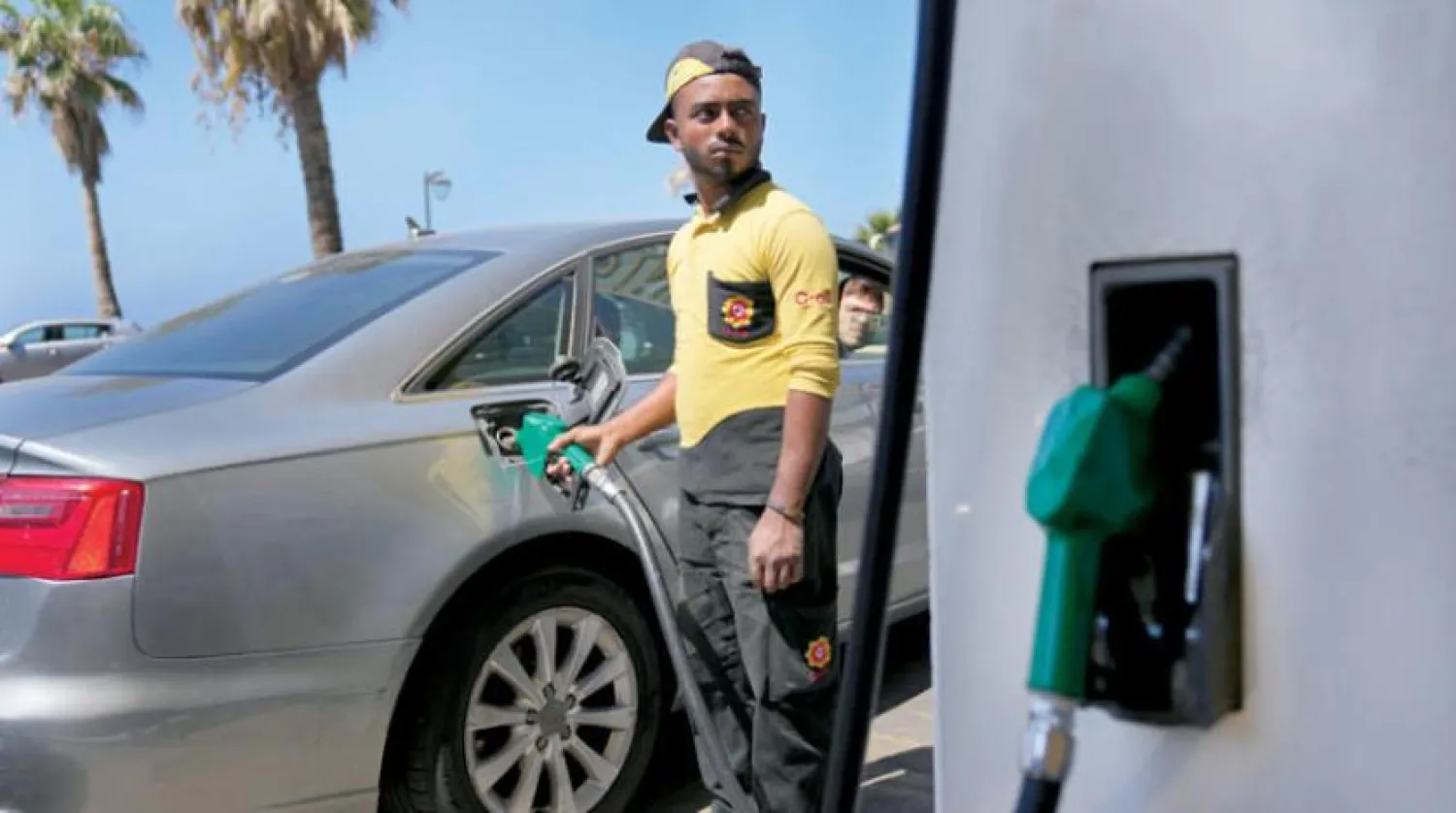 A worker at a station in Beirut fills the tank of a car with petrol (AP)