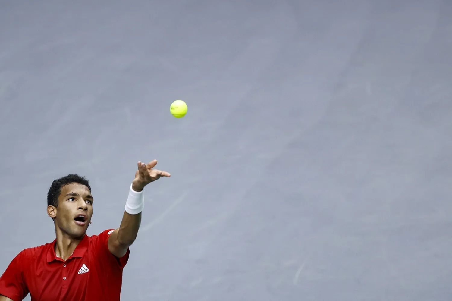 Canada's Felix Auger-Aliassime in action against Spain's Carlos Alcaraz during their singles match of the Davis Cup Finals group B tie between Spain and Canada in Valencia, eastern Spain, 16 September 2022. (EPA)