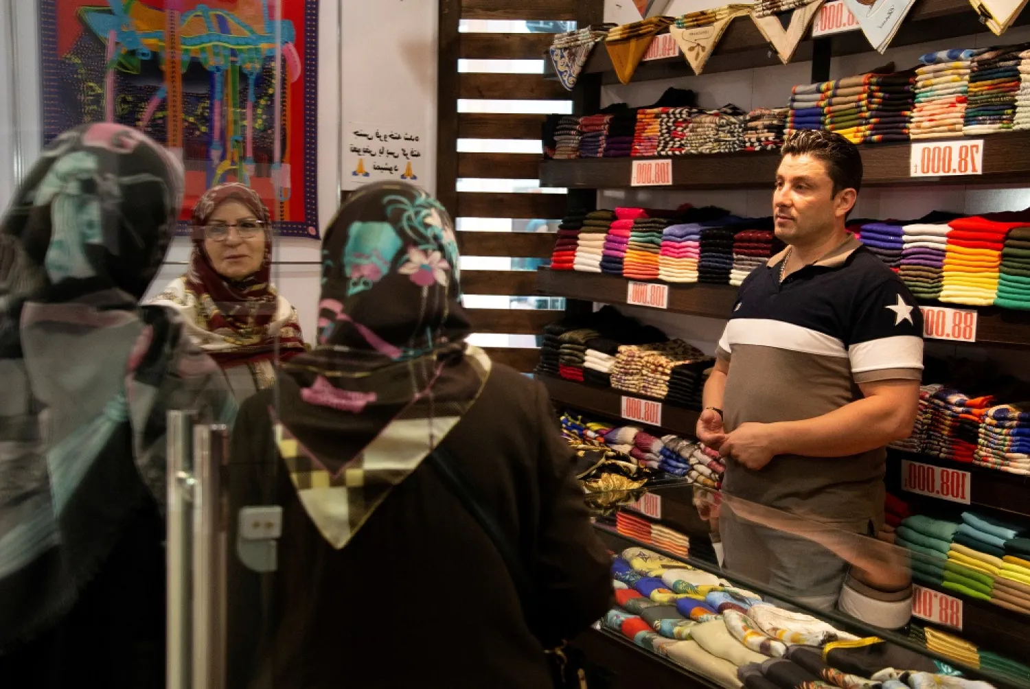 Women shop for scarves of Iranian scarf brand Devora at Kourosh mall in western Tehran, Iran June 22, 2019. Picture taken June 22, 2019. (Wana News agency via Reuters)