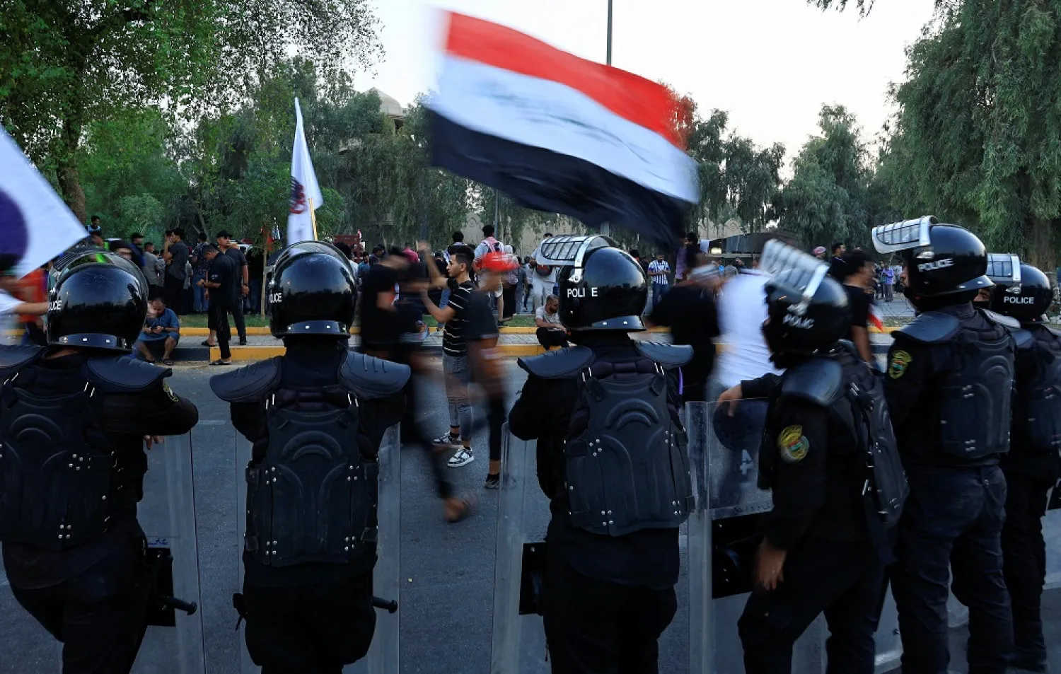 Police officers stand guard as Iraqi demonstrators gather during an anti-government protest in Baghdad, Iraq September 2, 2022. (Reuters)