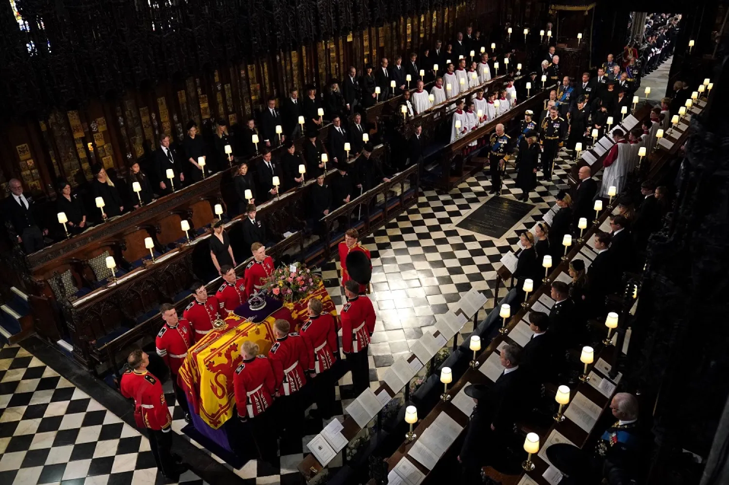The Bearer Party carry the coffin of Queen Elizabeth II, followed by Britain's King Charles III into St George's Chapel inside Windsor Castle on September 19, 2022, for the Committal Service for Britain's Queen Elizabeth II. (AFP)