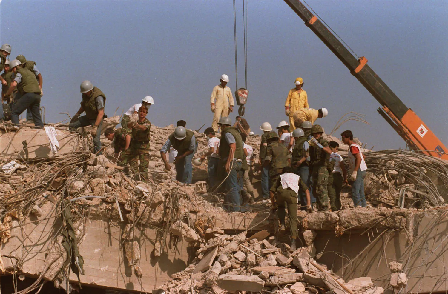 FILE - Rescue workers sift through the rubble of the US Marine base in Beirut in Oct. 23, 1983 following a massive bomb blast that destroyed the base and killed 241 American servicemen. (AP Photo, File)