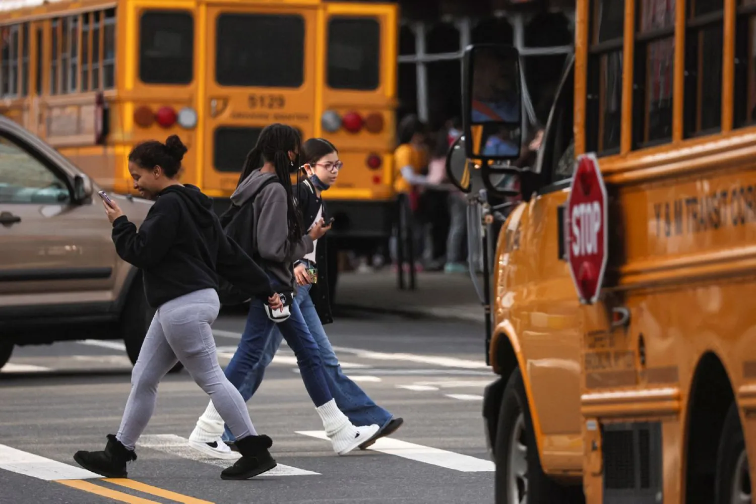 Children are seen walking to school, on the first day of lifting the indoor mask mandate for DOE schools between K through 12, in Brooklyn, New York City, New York, US March 7, 2022. REUTERS/Brendan McDermid
