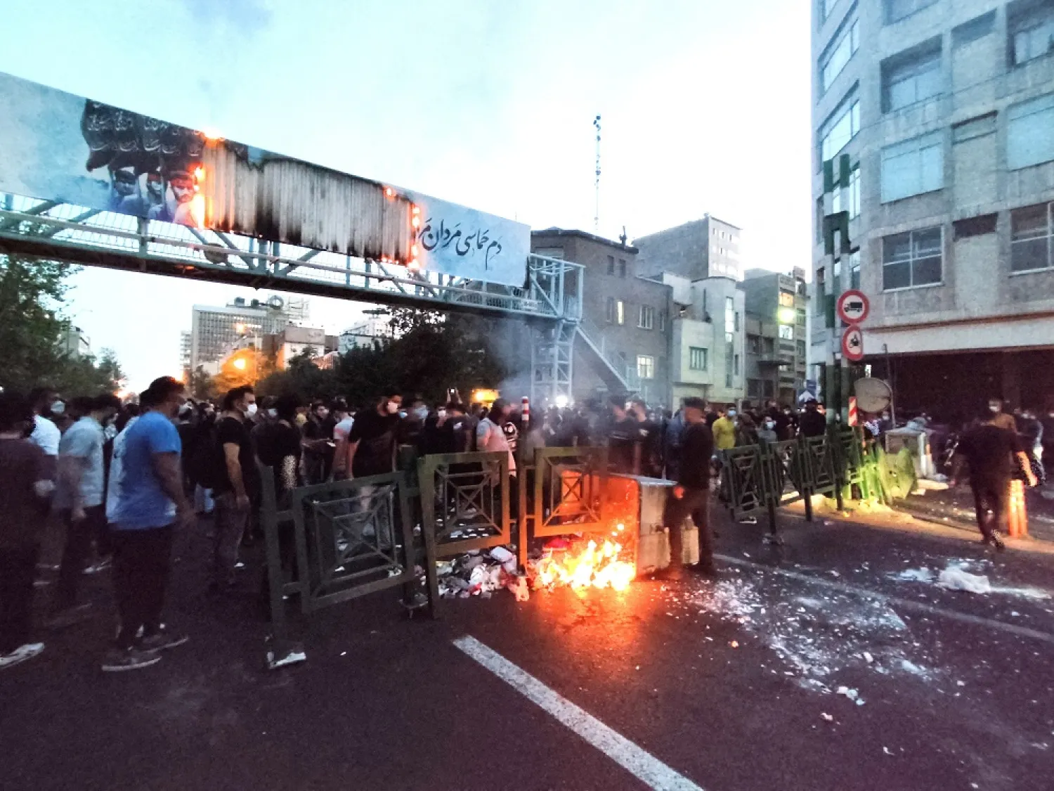 People light a fire during a protest over the death of Mahsa Amini, a woman who died after being arrested by the country's "morality police", in Tehran, Iran September 21, 2022. (West Asia News Agency via Reuters)