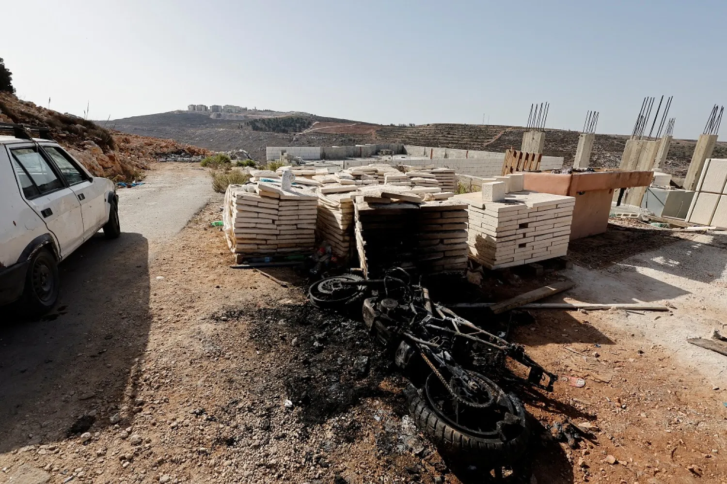 A burnt vehicle lies on the ground at the scene of an exchange of fire between Palestinian gunmen and Israeli forces in a raid in Nablus, in the Israeli-occupied West Bank, September 25, 2022. (Reuters)