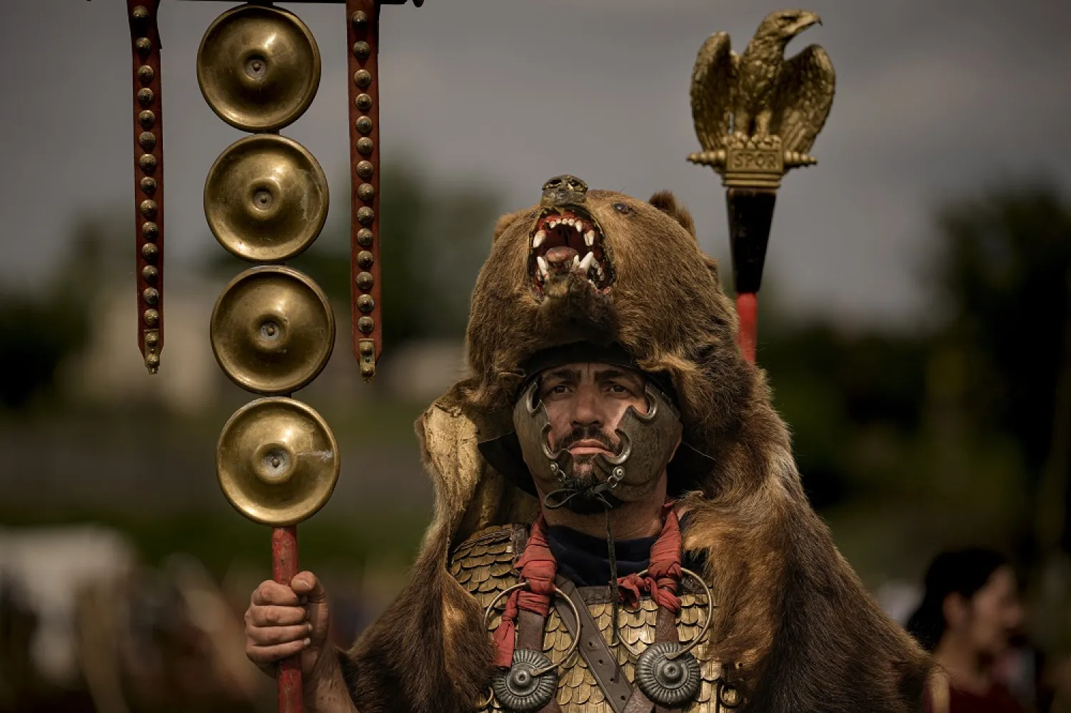 A participant in the Romula Fest historic reenactment event, wearing a Roman legion uniform and a bear fur stands in the village of Resca, Romania, Sunday, Sept. 4, 2022. (AP)