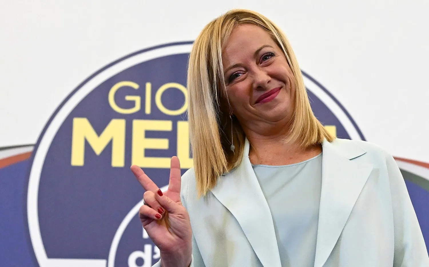 Leader of Brothers of Italy (Fratelli d'Italia) Giorgia Meloni gestures the V sign at the party's headquarters in Rome, Italy, 26 September 2022. (EPA)