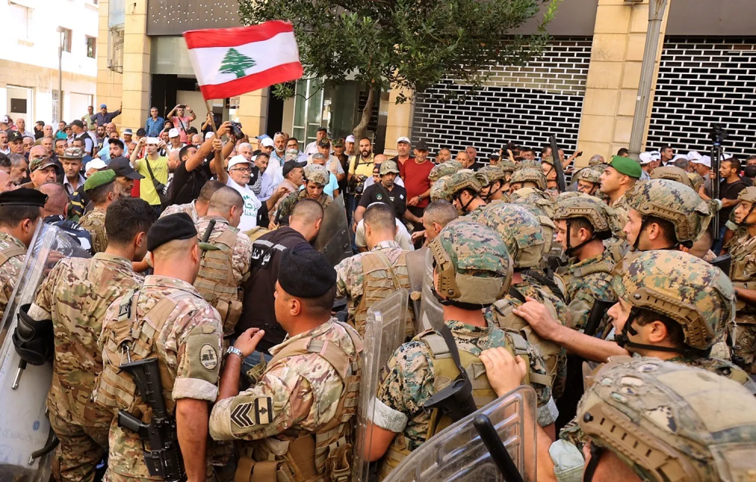 Lebanese army soldiers clash with retired military personnel as they try to break into the parliament in Beirut on September 26, 2022, during a session to approve the 2022 budget. (AFP)